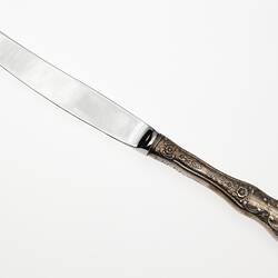 Knife with curved end, detail on handle.