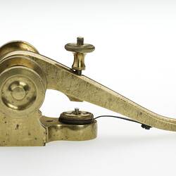 Curved brass pivoted lever, fitted with ivory knob. Profile.