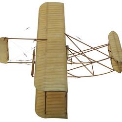 Wooden model aeroplane. Two sets of lacquered fabric wings, front stabilisers, back rudder. Two propellers.
