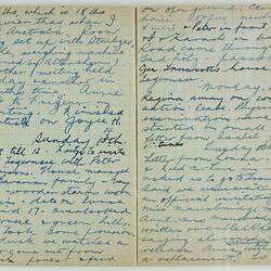 Open book, 2 cream pages with faint grid pattern. Cursive handwritten text in blue ink. Page 28 and 29.