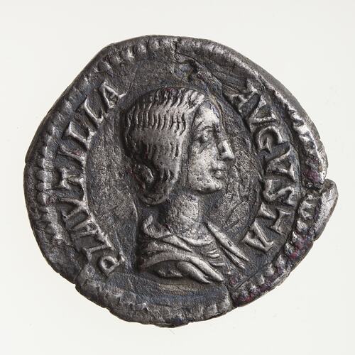 Roughly round silver coin. Draped bust of woman facing right. Text around.