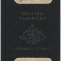 Dark blue passport front cover with gold printing. Coat of arms in centre. Cut out strip at top and base.