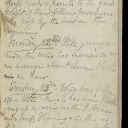 Open diary with handwritten text on discoloured worn page.