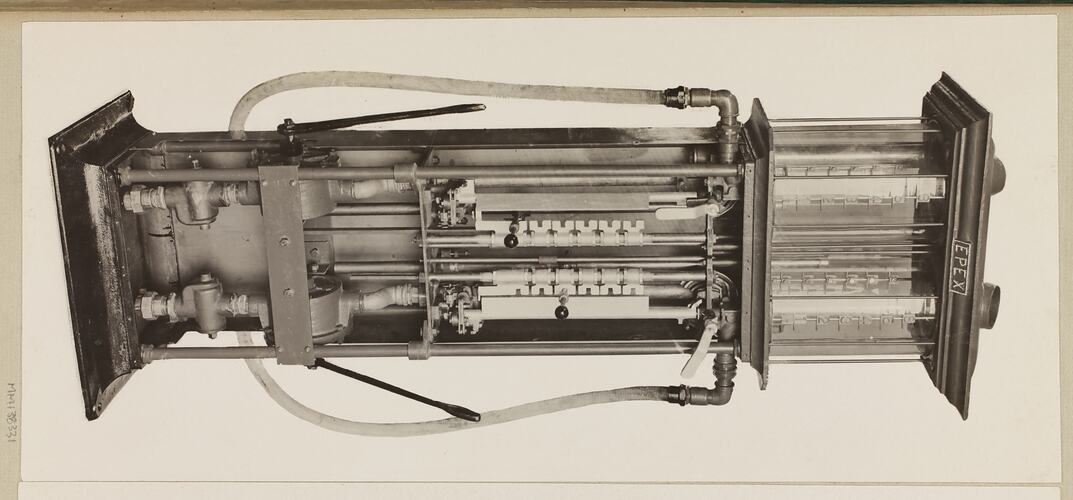 Monochrome photograph of a twin cylinder petrol pump.