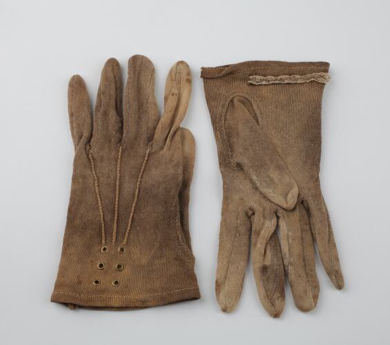 Pair of mid-brown cotton gloves, one upside down