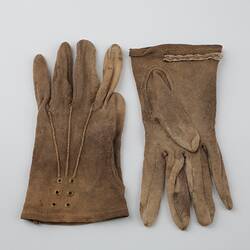 Pair of mid-brown cotton gloves, one upside down