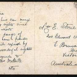 Postcard with handwritten text and red stamp in top-right corner.