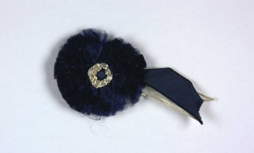 Front of blue and white rosette.
