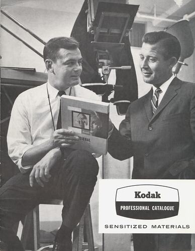 Cover page with photograph of men reviewing film.
