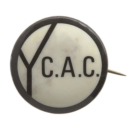 Round white badge with black border and central text. Oversized Y at left. Reads Y.C.A.C.