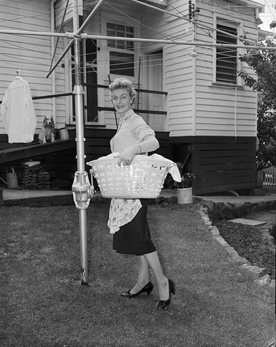 Woman Using a Plastic Clothes Basket, Melbourne, Victoria, Nov 1958