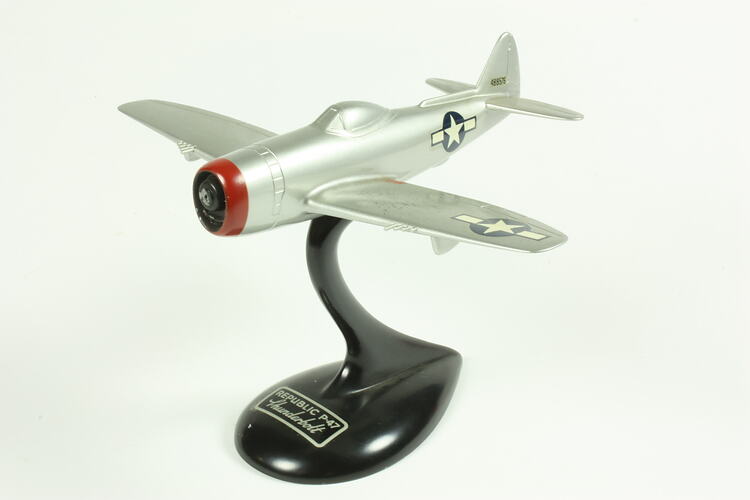 Silver model aeroplane on black stand.