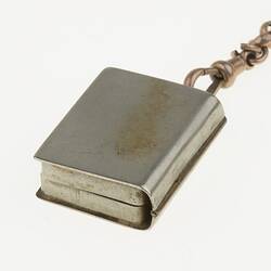 Detail of silver watch chain with miniature book in silver case. Reverse.