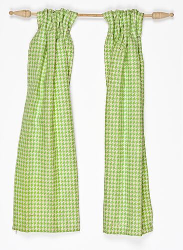 Miniature green and white chequered curtains from a doll's house.