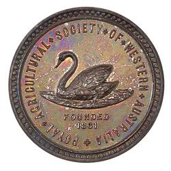 Round bronze-coloured medal with swan in centre, text around edge.