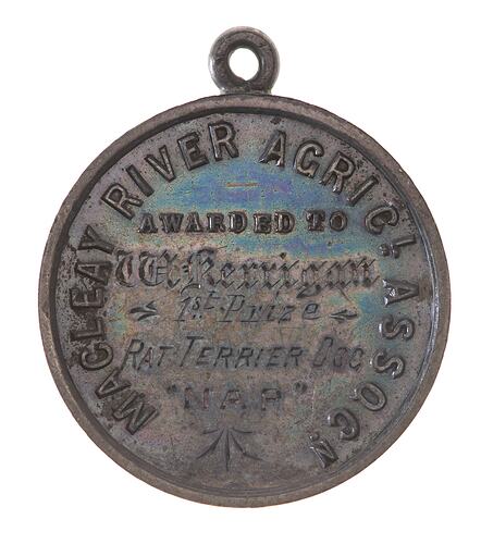 Round silver medal with suspension loop. Raised and engraved text.
