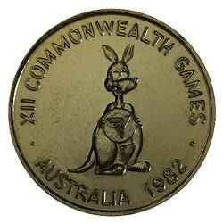 Round gilt medal with kangaroo caricature standing facing 3/4 right holding Brisbane Commonwealth Games logo.