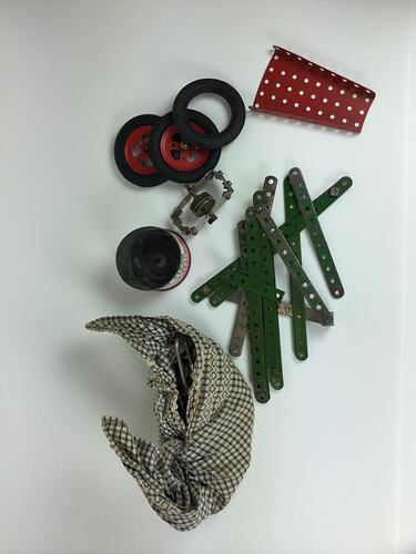 Assorted construction pieces with cloth containing parts.