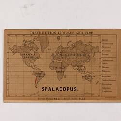 Retangular brown card with black and red text and map