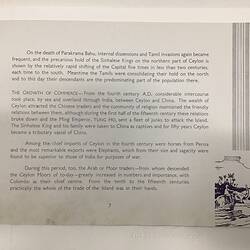 White page with dark blue text. Sketch of two figures on elephants in water at lower right.