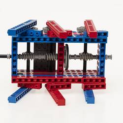 Red, blue and grey LEGO robot with three legs either side. Underside view.