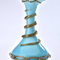 Pale blue opaque glass vase with gilded ribbon spiralling from base up to top. Flared neck with frill at top.
