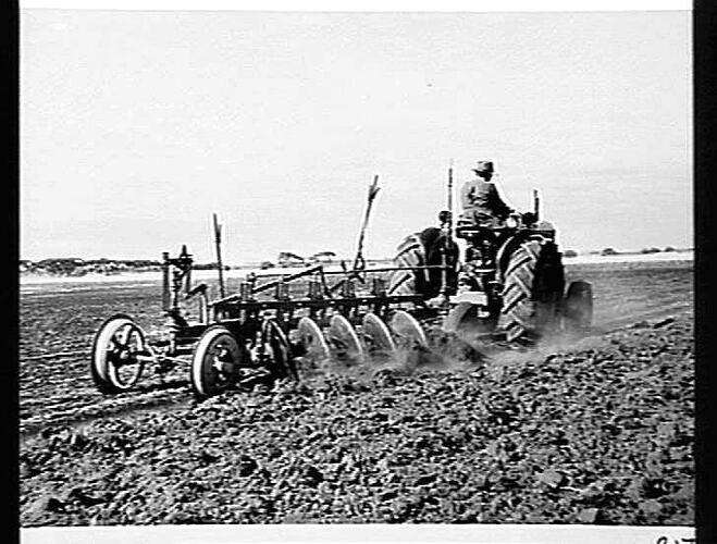 MR. J. CAMPBELL OF ROCKBANK, VIC, PLOUGHING HARD SUN-BAKED CLAY SOIL WITH A 44K TRACTOR AND 5 FURROW SUNVERTICAL DISC PLOUGH
