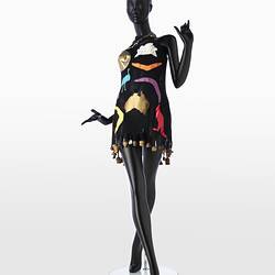 Short, black dress with coloured cut outs of Sydney Opera House, Uluru, an emu, kangaroo, and boomerangs.