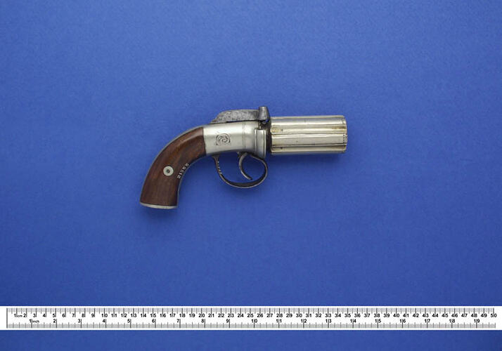 Antique revolver with ruler.