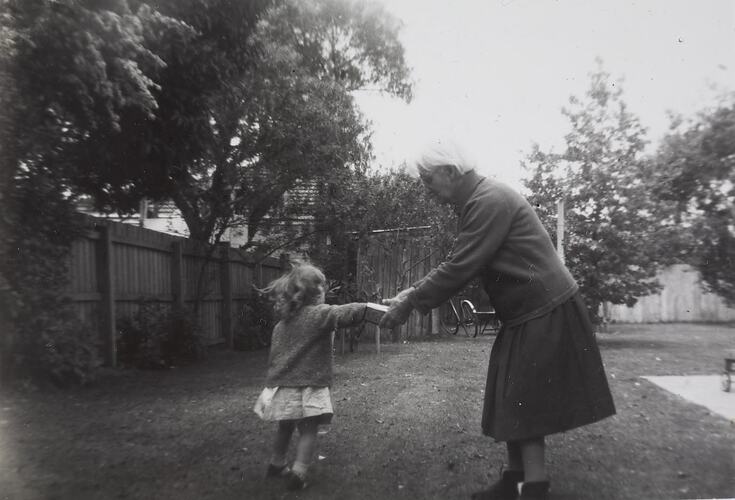 Digital Photograph - Woman Giving Granddaughter a Lolly, Backyard, Parkdale, circa 1965