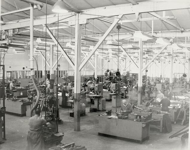 Workers in a large tool room.