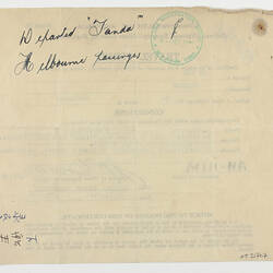 Reverse of a form with handwriting and a green stamp.