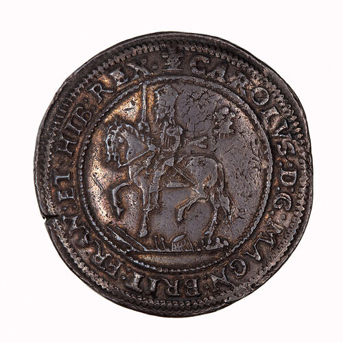 Coin, round, within a circle of beads, crowned King wearing armour and a long scarf, holding sword upright.