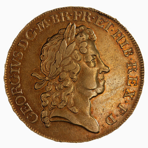 Round gold coin with head.