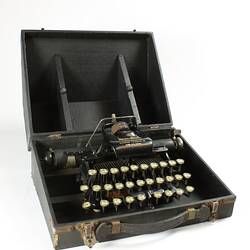 Black typewriter in case.