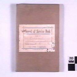 Front cover of a book with a torn label.