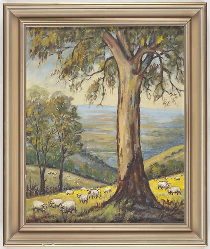Framed painting of hills, tree and sheep.