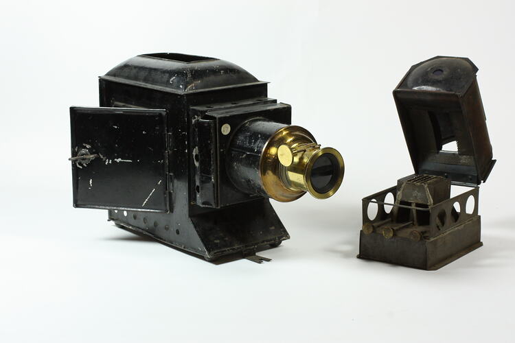Two-piece metal slide projector with side door and brass lens fitting