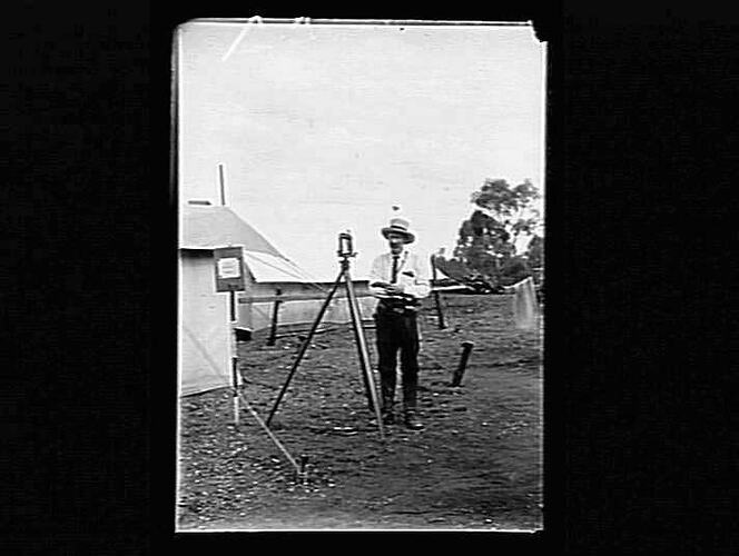 Surveyor with equipment and tents.