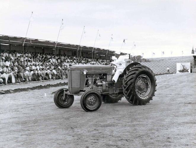 Tractor on display in front of grandstand.