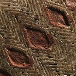Detail of diamond pattern on a wooden shield.