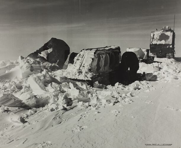 Two Men with Weasel Vehicle & Sleds, The Australian National Antarctic Research Expedition (ANARE), Antarctica, circa 1950s