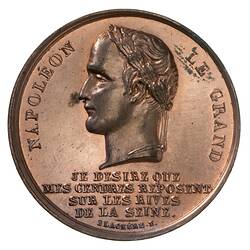 Round medal with male profile facing left. Text below and around.