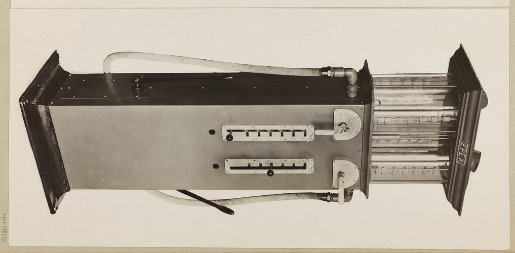 Monochrome photograph of a twin cylinder petrol pump.