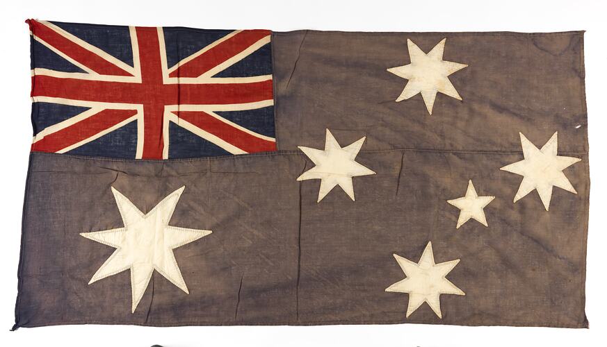 Faded Australian flag with horizontal seam at centre.