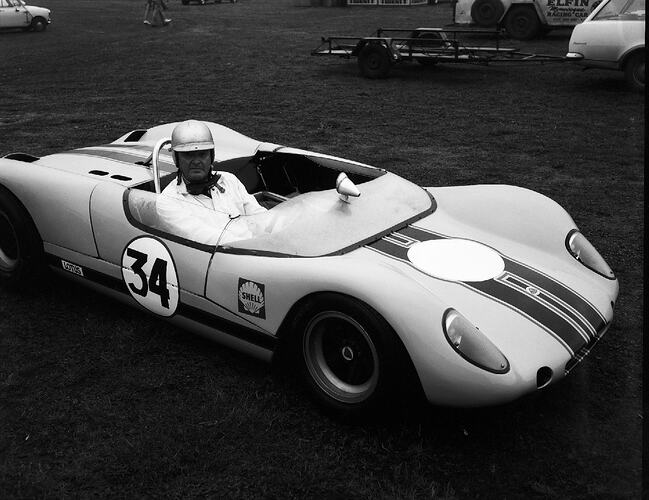 Monochrome photograph of a racing car.