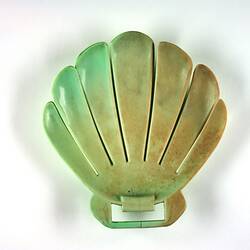 Shell-shaped green plastic form