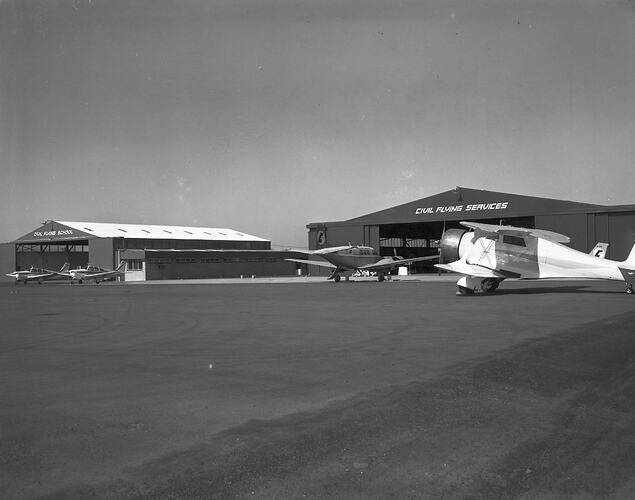 Monochrome image of an aircraft hangar.