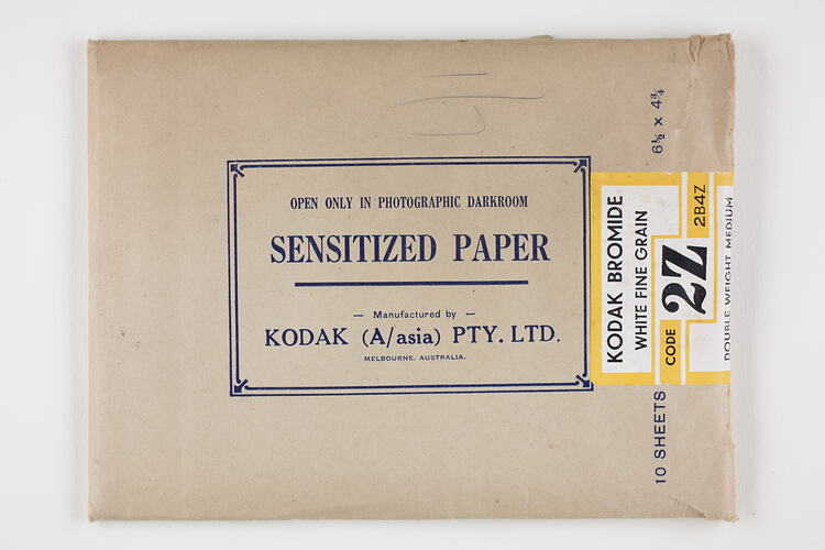 Brown paper packet sealed with printed label.