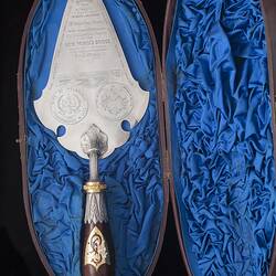 Silver decorative engraved trowel with detailed handle. Blue silk lined box.